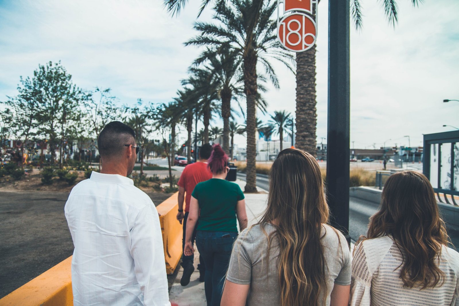 group of people walking on a sidewalk